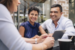 A middle-aged Latino couple works with a financial advisor