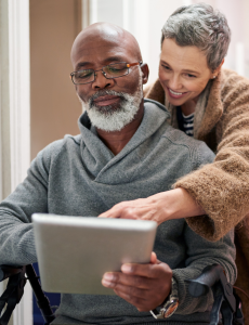 man and woman looking at a tablet