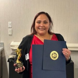 Maryvette, holding an award from the Midstate Chamber of Commerce