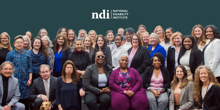 disability-pride-2025-c Group photo of National Disability Institute staff smiling and gathered together in front of a bright teal background with colorful confetti falling. The NDI logo appears in the upper right corner. Across the bottom of the image, large text reads “Disability Pride Month 2025.”