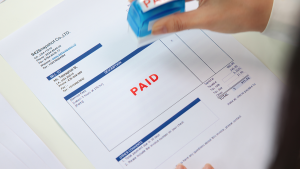 image of a bill with a red paid stamp on it.